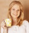 Young cute blond girl drinking coffee close up on warm brown background