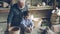 Young cute boy is making clay figure on throwing wheel while his grandfather experienced sculptor is standing near