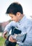 Young cute boy playing guitar
