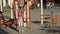 Young cute child girl in sportswear making fitness jump exercises on playground. Workout for kids