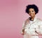 Young cute disco african-american girl on pink background smiling adorable emotions copyspace, lifestyle people concept