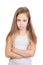 Young cute displeased girl with grey blue eyes, long light brown hair and crossed arms