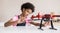 Young cute girl holding quadcopter. Child playing with drone at home.