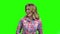 Young cute girl is laughing on green screen.