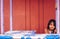 Young cute little girl standing right on a food stall