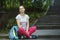 Young cute sporty girl is sitting outdoors.