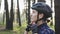 Young cute triathlete puts on black cycling helmet. Happy cyclist portrait. Triathlon concept.