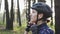 Young cute triathlete puts on black cycling helmet. Happy cyclist portrait. Triathlon concept. Slow motion