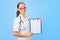 Young cute woman doctor holding clipboard