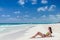 Young cute woman lying and getting some sun at tropical sandy beach