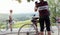 A young cyclist woman takes a break on the roadside, during a cycling race in the Tuscan countryside