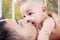 Young dad kiss baby\'s mouth