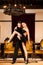 Young dance couple preforming latin show dance in ancient ballroom