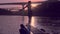 Young dancing woman on river Douro boat station, Porto in sunset