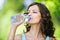 Young dark-haired woman drinking