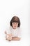 Young dark-haired woman with questioning expression. Portrait of girl on the floor on white background