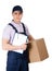 Young delivery man in overalls hands parcel