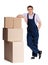 Young delivery man in overalls with pasteboard boxes