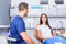 A young Dentist consulting a female Patient in the dental studio