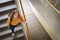 Young depressed lonely female college student walking down the stairs at her school, looking up at the camera.