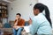 Young depressed man crying talking to mental health counselor during a session in the office. Stressed male at psychotherapy after