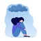 Young depressed woman sitting under metaphoric rainy cloud. Lonely sad female hugging her knees. Concept of depression