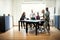 Young designers playing table tennis inside of an office boardro