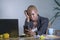 Young desperate and stressed african american business woman working at laptop computer desk at office suffering stress problem us