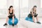 Young, determined Asian woman exercise alone at home gym or sports club, sit on fitness ball with mirror