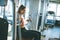 Young determined fitness woman doing exercises at chest press machine at modern gym