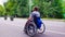 Young disable man walking in the park in wheelchair