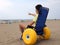 Young disabled boy in a special wheelchair with big inflatable w