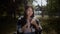 A young disabled girl in a wheelchair is searching through the Internet on the phone, enjoying a good warm weather in a