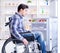 Young disabled injured man opening the fridge door