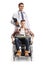 Young disabled male in a wheelchair and a doctor standing behind him