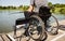 Young disabled man in a wheelchair fishing.