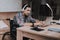 Young Disabled Man on Wheelchair Working at Home.