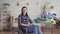 Young disabled woman housewife washing clothes, housework, looking at the camera, smiling