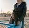 Young disabled woman in wheelchair with her mother walking near the sea on the ramp for people with disabilities. Family