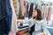 Young disabled woman in wheelchair shopping for clothes