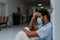 Young distressed doctor sitting at hospital corridor floor.