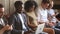 Young diverse people using laptops and smartphones sitting on couch