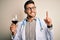 Young doctor man wearing stethoscope drinking a glass of fresh wine over isolated background surprised with an idea or question