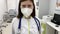 Young doctor in the mask. Closeup portrait of female doctor in clinic.