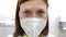 Young doctor in the mask. Closeup portrait of female doctor in clinic.