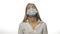 Young doctor in a medical mask is experiencing a migraine at work, massaging the temporal lobes of the head, looking at