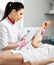 Young doctor performes a procedure on patient hand with medical equipment in equiped beauty salon