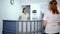 Young doctor Talking with Patient at Hospital Reception Desk