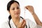 Young doctor woman with syringe against white background