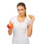 Young doubting girl with apple and hamburger